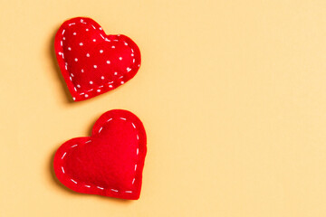 Composition of textile red hearts on colorful background with empty space for your design. Top view of St. Valentine's day concept