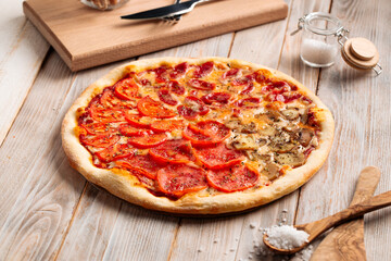 Assorted four seasons pizza on the wooden rustic table