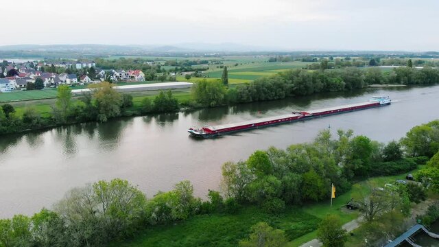 Aerial view of a freight transport ferry on a river in Germany - pan, drone shot