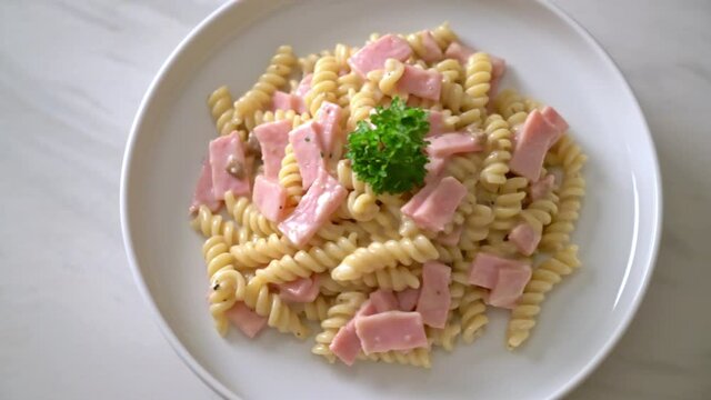 spirali or spiral pasta mushroom cream sauce with ham - Italian food style