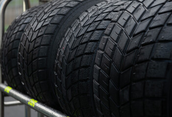 Fototapeta na wymiar Wet tire set close up, motorsport car racing equipment