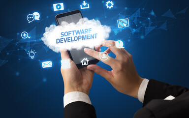 Female hand holding smartphone with SOFTWARE DEVELOPMENT inscription, cloud technology concept