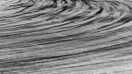 Abstract texture and background of car tire drift skid mark on road race track, Black tire mark on street race track, Automobile and automotive concept. © Kalyakan