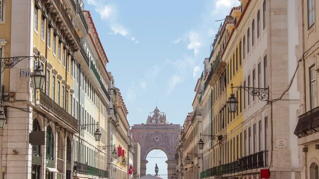 Time lapse of rua augusta arch in lisbon or lisboa near the  Praca do Comercio (the Commerce Square)  during a sunny cloudy day
