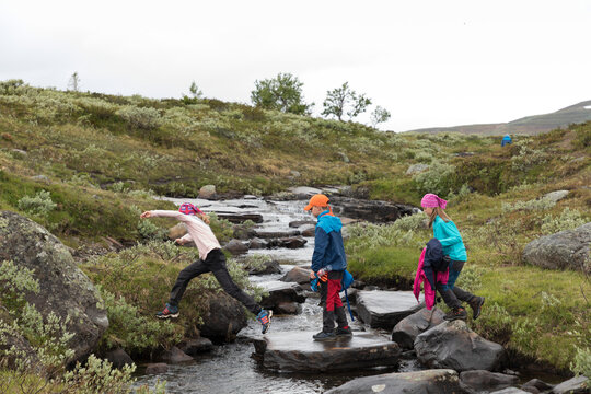 Girls crossing small river