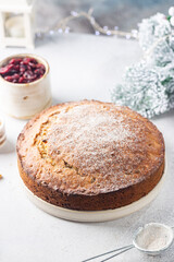Traditional Christmas cake pudding with fruits and nuts with Christmas decorations, light background