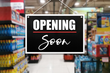 An opening soon sign of a supermarket or grocery store.