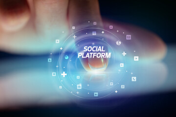 Finger touching tablet with social media icons and SOCIAL PLATFORM
