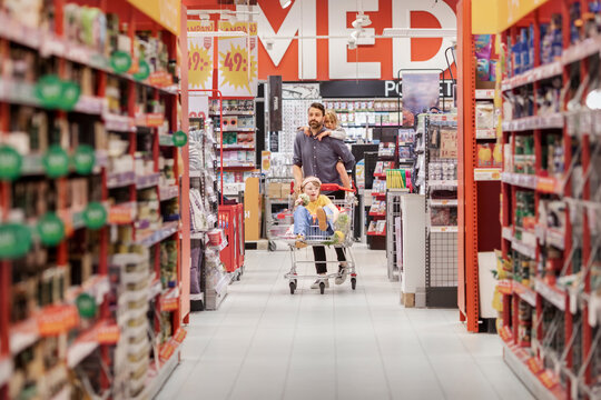 Father with daughters doing shopping in supermarket