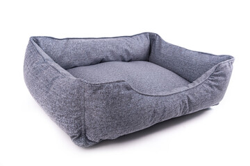 Empty blue dog bed on a white background. Angle view.