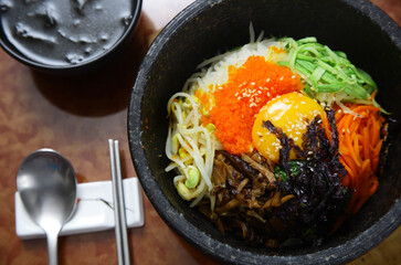 Korean cuisine : bibimbap in a heated stone bowl