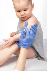 Doctor injecting a vaccine in arm of baby girl