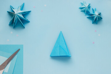 Simple origami 3D Christmas tree made from blue paper. Step by step instruction, step 15 Do steps...