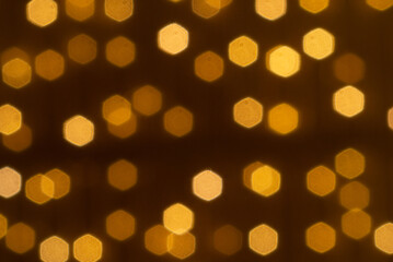 Abstract circular yellow bokeh in dark background, gold bubble.