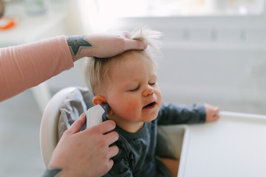 Mother checking toddler temperature