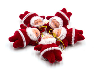 three funny santa claus toys with christmas bells on white background. In focus and out of focus