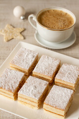 A square slices of festive Christmas white cake with vanilla cream filling