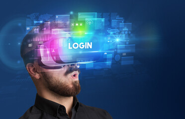 Businessman looking through Virtual Reality glasses with LOGIN inscription, innovative security concept