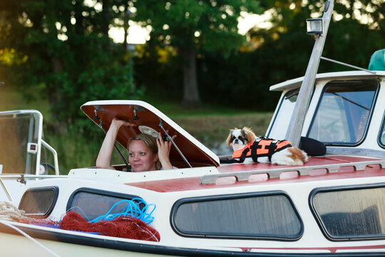 Woman on boat looking through hatch