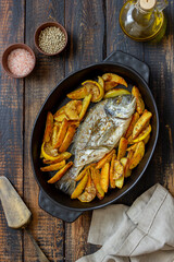 Dorado or sea bream baked with potatoes and lemon. Healthy eating. Diet.