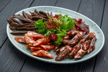 Traditional dry-cured sausage and jerky on a plate