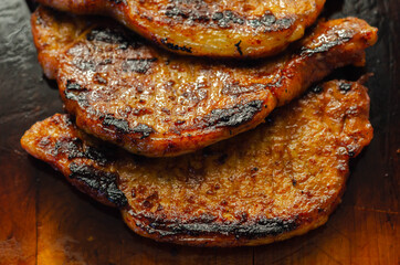 Fresh and juicy pork loin steaks,  grilled meats on the wooden board