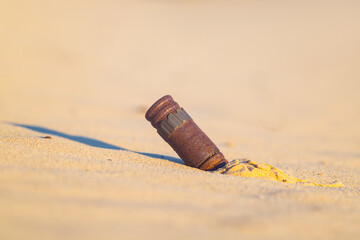 old rusty bullet lie on asand, echoes of war in a desert