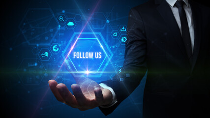 Man hand holding FOLLOW US inscription, social media concept