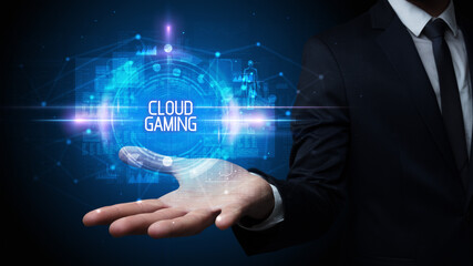 Man hand holding CLOUD GAMING inscription, technology concept