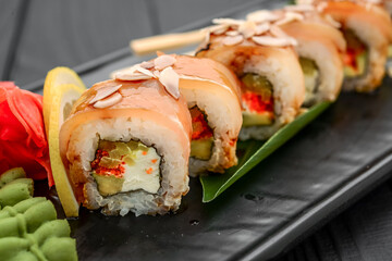Sushi rolls, nigiri, raw salmon, pickled ginger. Asian food.
