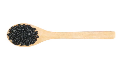 Black beluga lentils pile with wooden spoon isolated on white background, top view