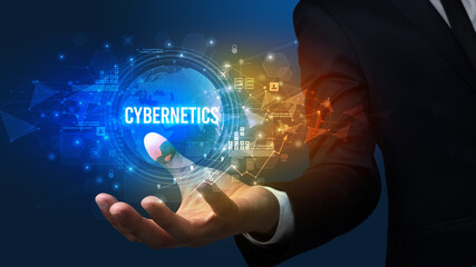 Elegant hand holding CYBERNETICS inscription, digital technology concept
