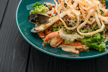 Fresh seafood salad with shrimps, mussels and vegetables