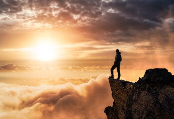 Magical Fantasy Adventure Composite of Man Hiking on top of a rocky mountain peak. Background...