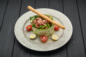 Fresh salad of tuna, cucumber, quail eggs and vegetables