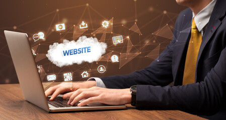 Businessman working on laptop with WEBSITE inscription, modern technology concept