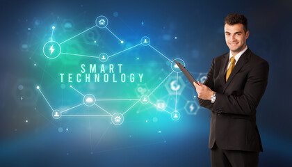 Businessman in front of cloud service icons with SMART TECHNOLOGY inscription, modern technology concept