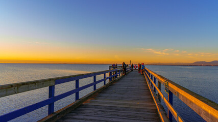 Fototapeta na wymiar Sunset at public fishing pier on Boundary Bay, BC early winter