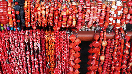 many red beads and bracelets made of stones