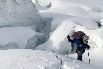 Mountain climber climb up the glacier. Descent from Marble Wall Peak, Central Tian Shan, Kazakhstan.