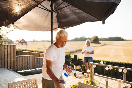 Man standing by table in garden