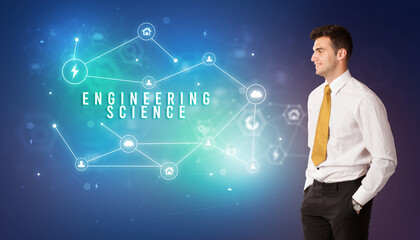 Businessman in front of cloud service icons with ENGINEERING SCIENCE inscription, modern technology concept