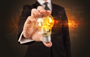 Businessman holding lightbulb with DIGITAL CURRENCY inscription, Business technology concept