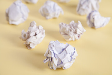 Set of crumpled paper balls, on an isolated yellow background.
