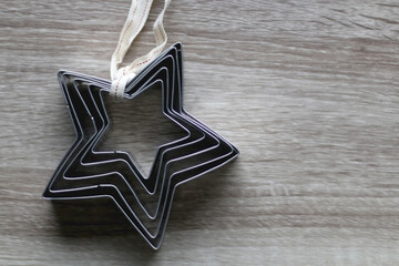 Star shaped cookie cutters on wooden background. Top view.