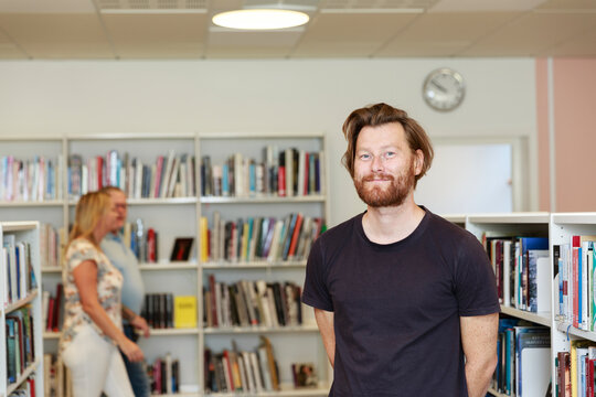 Man in library looking at camera