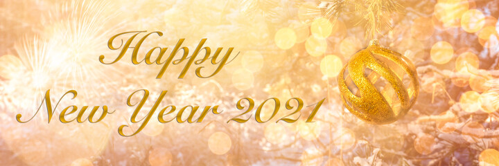 Happy New Year 2021! Blurred background of Christmas tree decorated with big golden ball. Bokeh. Fireworks. Celebration. Header. Greeting Postcard. 1st January.