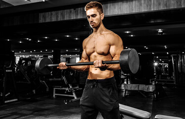 Fototapeta na wymiar muscular bodybuilder doing heavy deadlift with a barbell in a modern gym