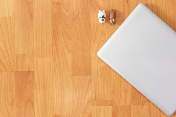 Working table with computer laptop, dolls and copy space on wood desk background, Top view style, Minimal workspace, business Concept
