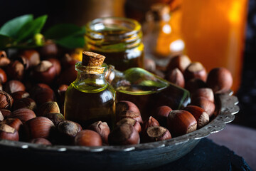 Concept of organic vegetable oils for cooking and cosmetology. Hazelnut oil and fresh nuts.